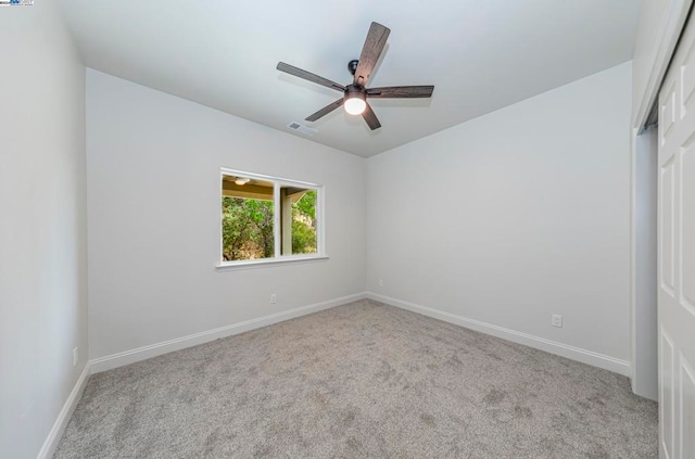 spare room with light carpet and ceiling fan