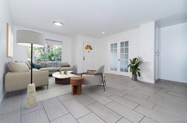 living room featuring french doors and light hardwood / wood-style floors