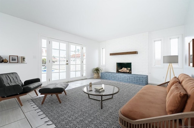 living room featuring french doors and a fireplace