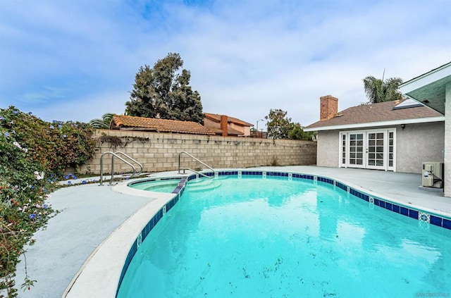 view of pool with an in ground hot tub and a patio area