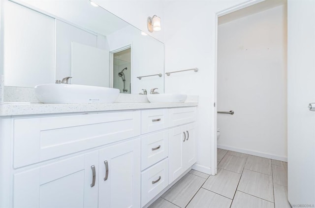 bathroom with vanity, toilet, and walk in shower