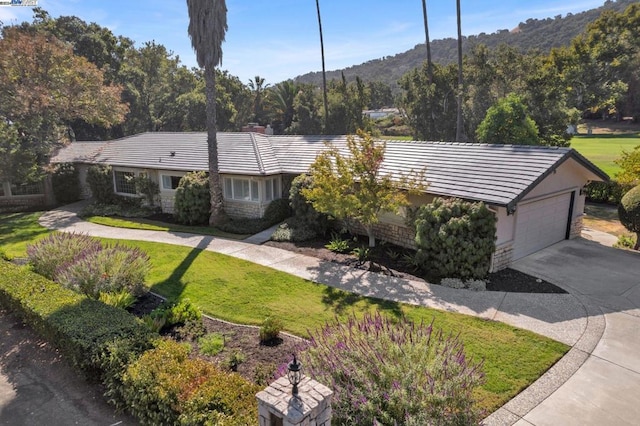 view of front of home with a mountain view and a front yard