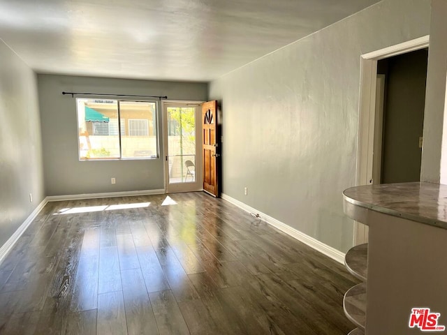 spare room with dark hardwood / wood-style floors