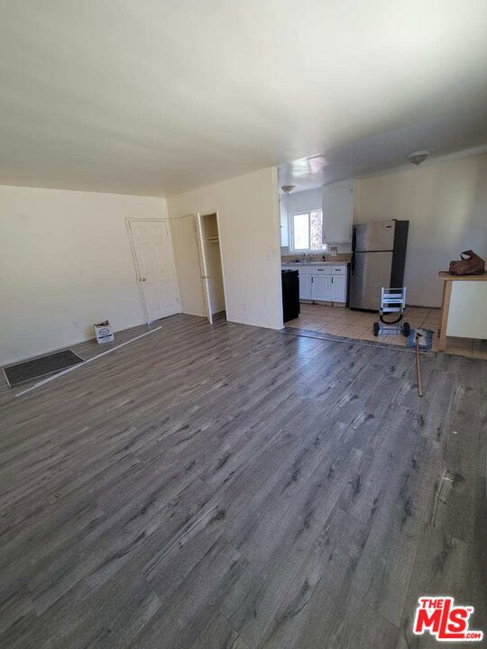 unfurnished living room featuring dark hardwood / wood-style floors