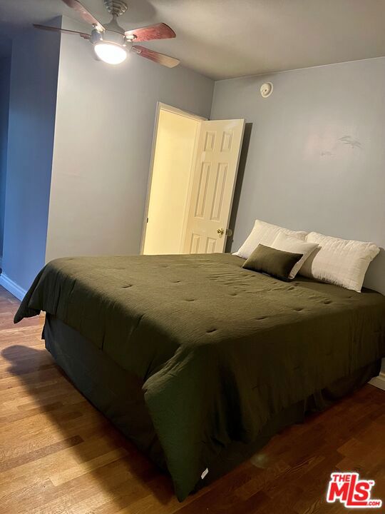 bedroom featuring wood-type flooring and ceiling fan