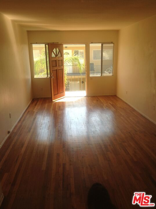 empty room with dark wood-type flooring