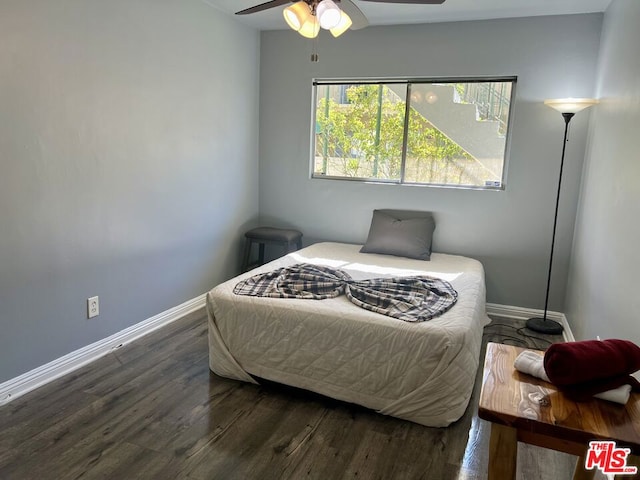 bedroom with dark wood-type flooring and ceiling fan