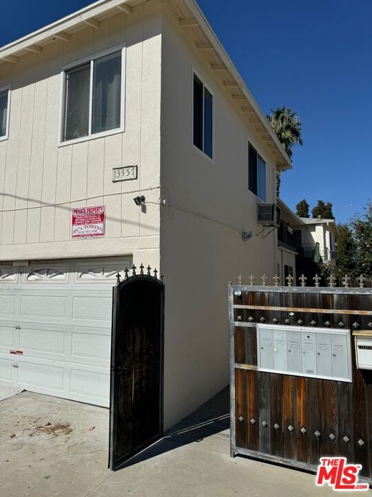 view of property exterior with mail boxes and a garage