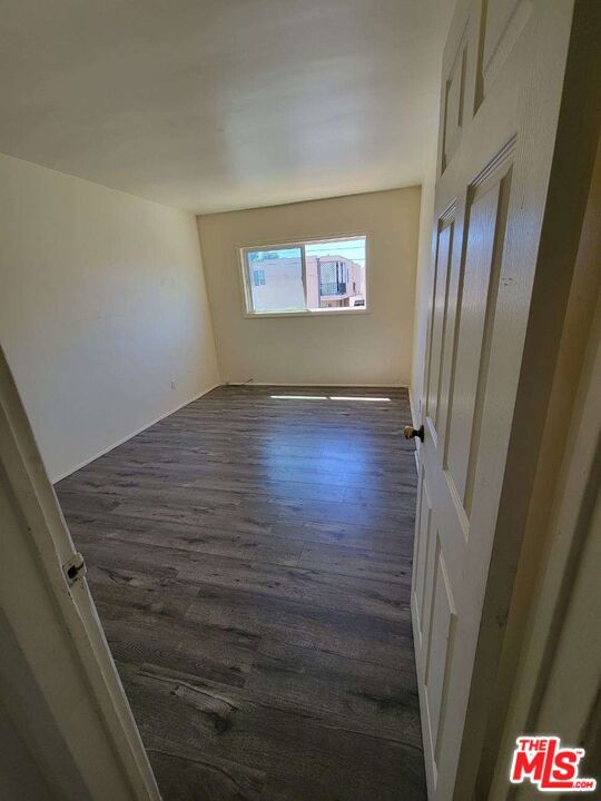 unfurnished room featuring dark hardwood / wood-style flooring