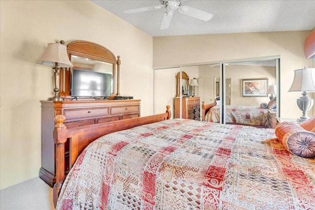 bedroom with lofted ceiling, a closet, and ceiling fan