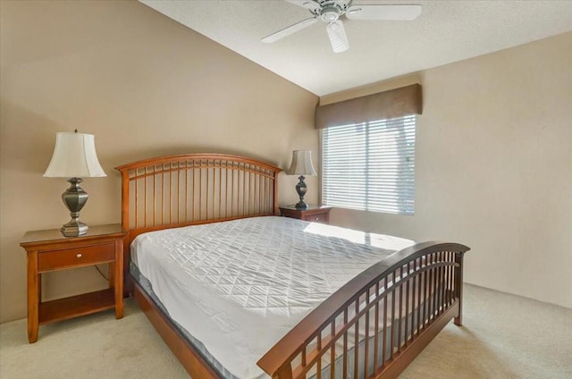 bedroom featuring vaulted ceiling, light carpet, and ceiling fan