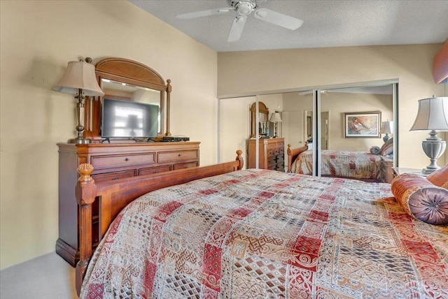 bedroom featuring a closet, a textured ceiling, vaulted ceiling, and ceiling fan