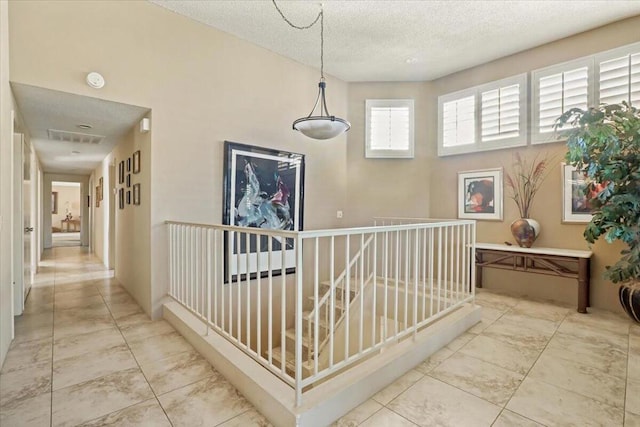 hallway featuring a textured ceiling