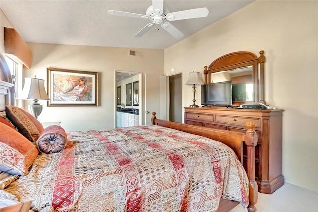 bedroom with lofted ceiling, ensuite bath, and ceiling fan