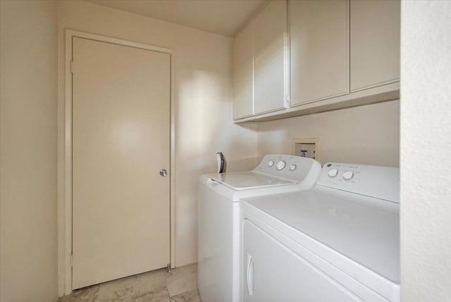 washroom with cabinets and washing machine and clothes dryer