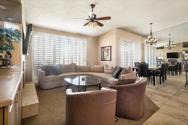 living room with lofted ceiling, a textured ceiling, ceiling fan with notable chandelier, and light tile patterned floors