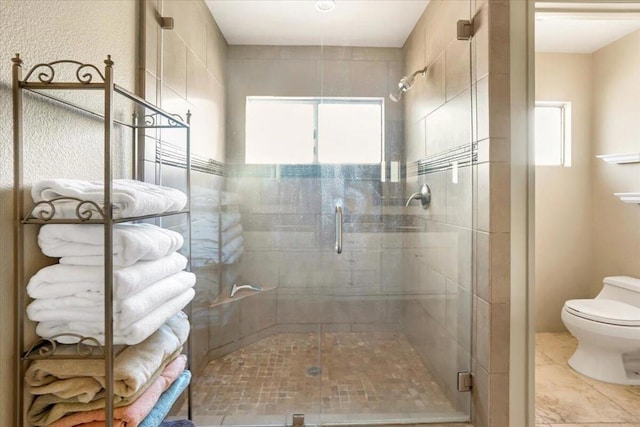 bathroom with toilet and an enclosed shower