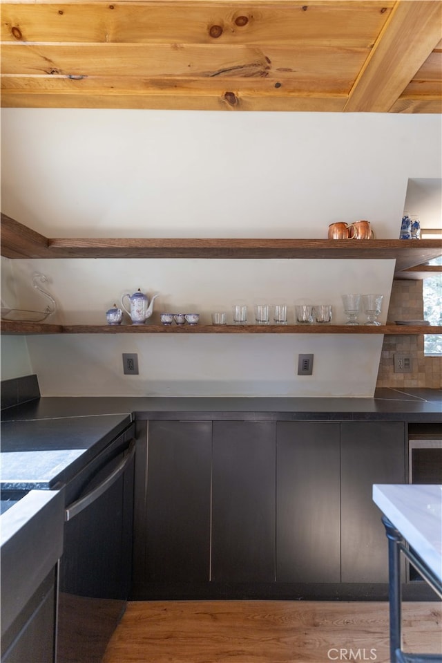 kitchen with decorative backsplash, wooden ceiling, and light wood-type flooring