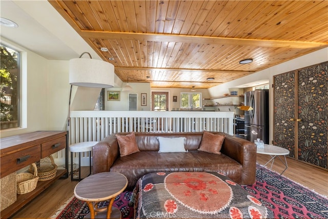 living area featuring lofted ceiling, hardwood / wood-style floors, and wood ceiling