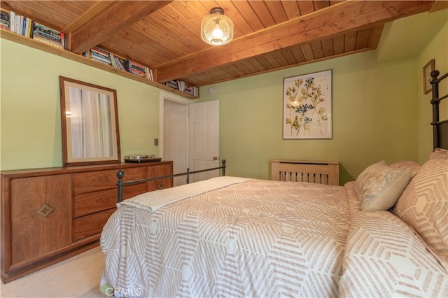 bedroom featuring carpet flooring, beam ceiling, and wooden ceiling