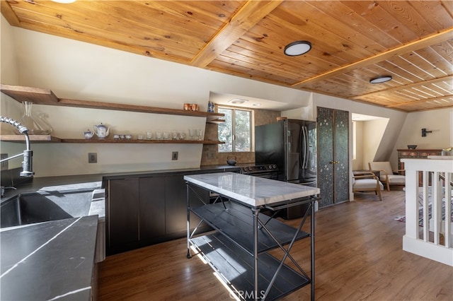 kitchen featuring sink, wood ceiling, dark hardwood / wood-style flooring, and black fridge