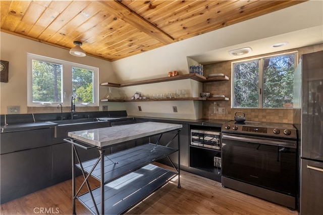 kitchen featuring light hardwood / wood-style floors, wood ceiling, stainless steel appliances, and sink