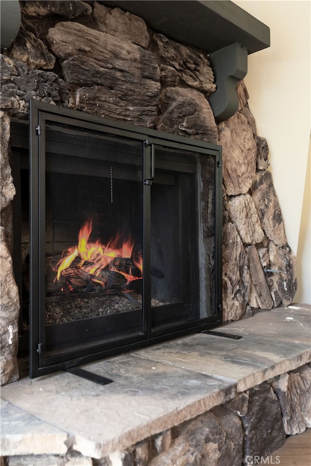 interior details featuring a stone fireplace