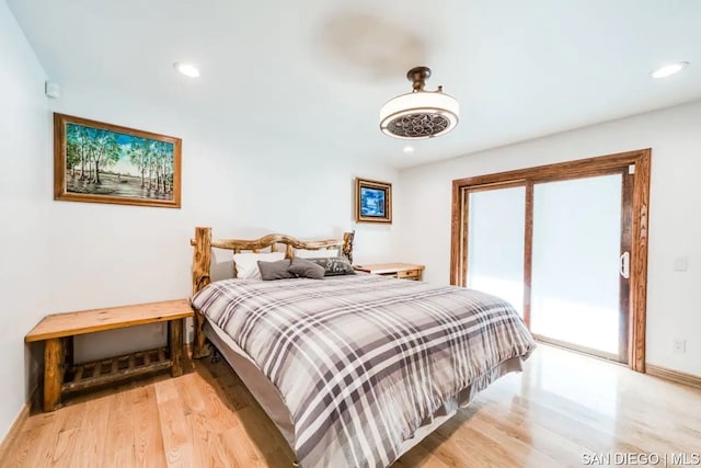 bedroom with access to outside and light wood-type flooring