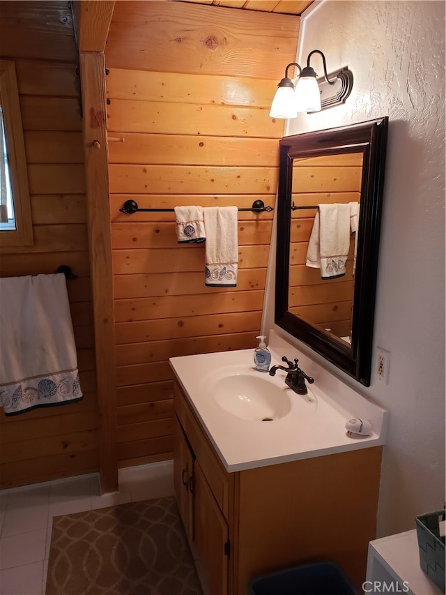 bathroom featuring vanity, tile patterned floors, and wooden walls