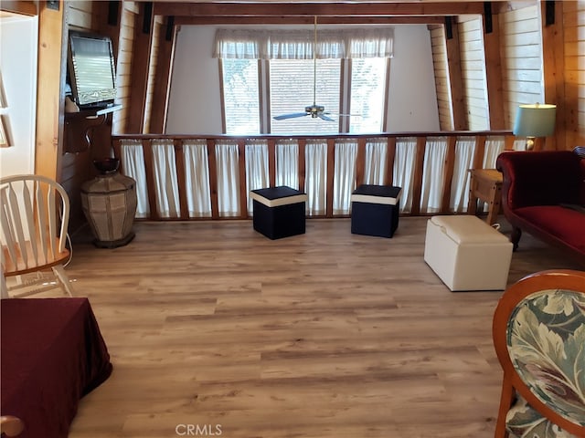 sitting room with ceiling fan and hardwood / wood-style flooring