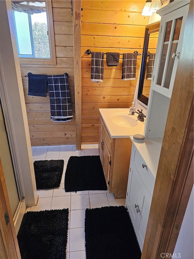 bathroom with vanity, wooden walls, and tile patterned flooring