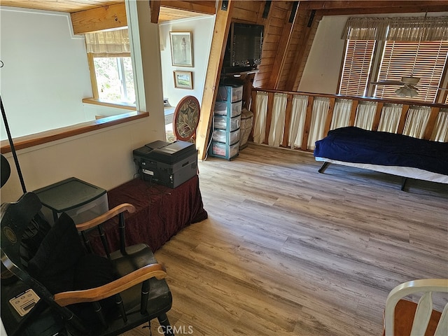 living area with wooden walls and hardwood / wood-style flooring