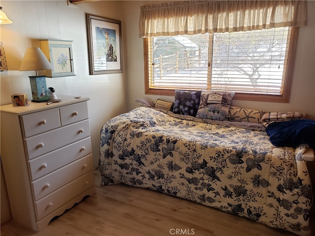 bedroom featuring multiple windows and light hardwood / wood-style floors