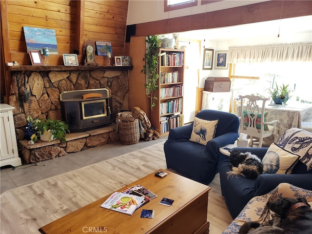 living room with a wood stove and light wood-type flooring