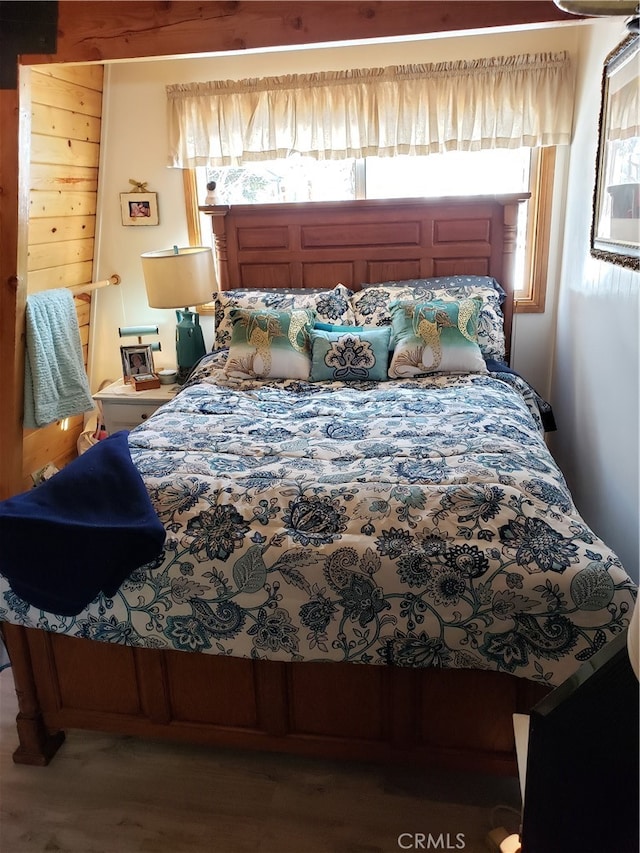 bedroom featuring wood-type flooring and multiple windows