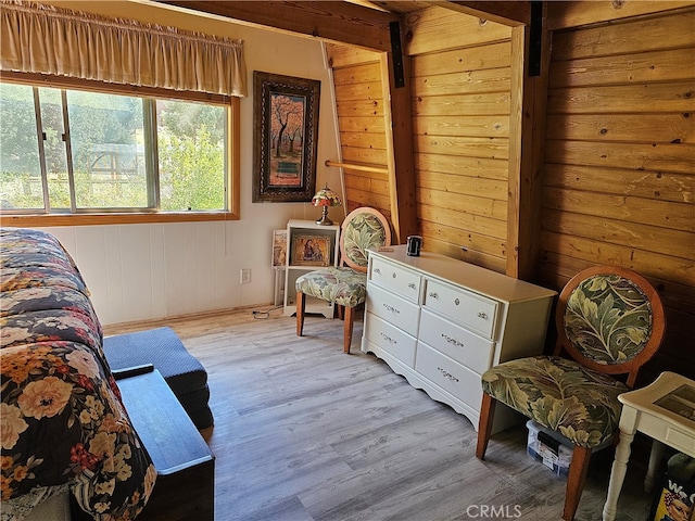 living area featuring wood walls and light hardwood / wood-style flooring