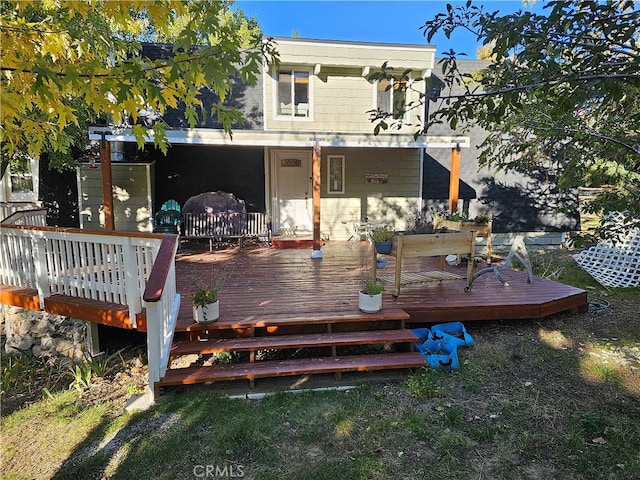 rear view of house featuring a deck