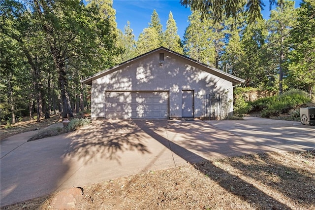 view of property exterior featuring a garage and an outbuilding