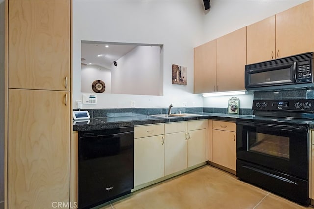 kitchen with sink, light brown cabinets, light tile patterned floors, and black appliances