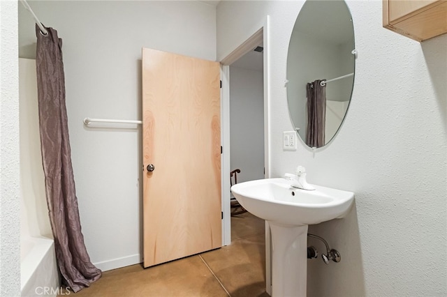 bathroom with tile patterned flooring, sink, and shower / bath combination with curtain