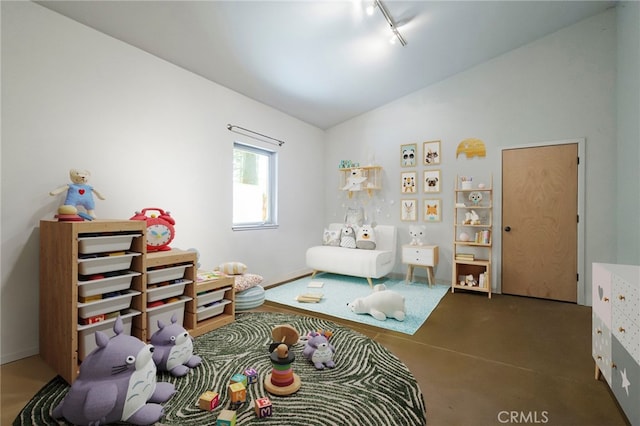 bedroom with rail lighting and vaulted ceiling