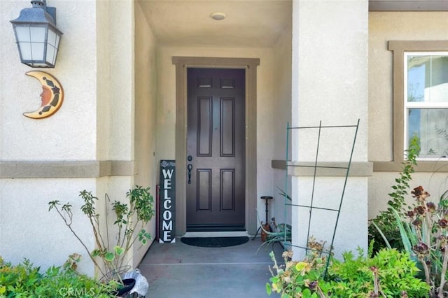 property entrance with stucco siding