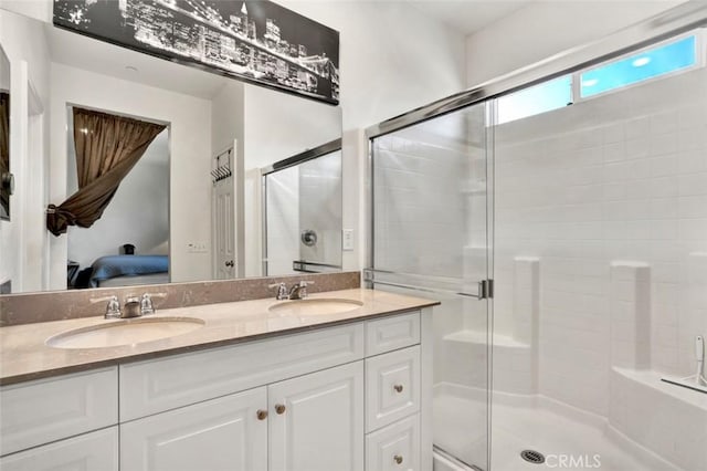 ensuite bathroom with a sink, a stall shower, and ensuite bathroom