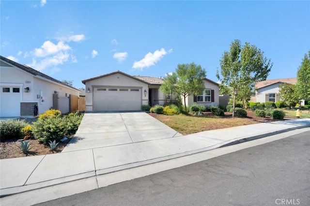 single story home featuring stucco siding, concrete driveway, and a garage