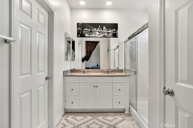 bathroom featuring a stall shower, recessed lighting, and vanity