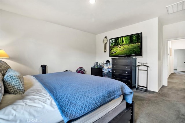 carpeted bedroom featuring visible vents