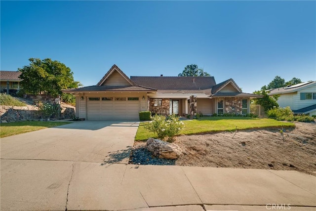 ranch-style home with a front lawn and a garage