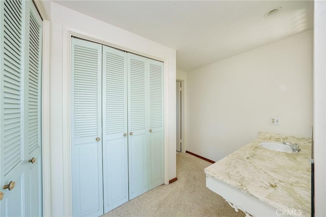 carpeted bedroom featuring sink