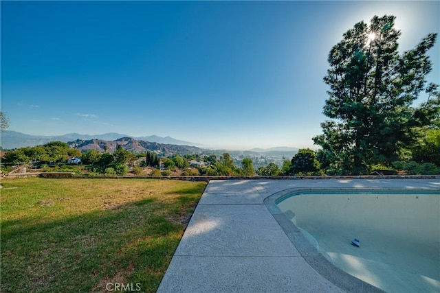 exterior space featuring a mountain view and a yard