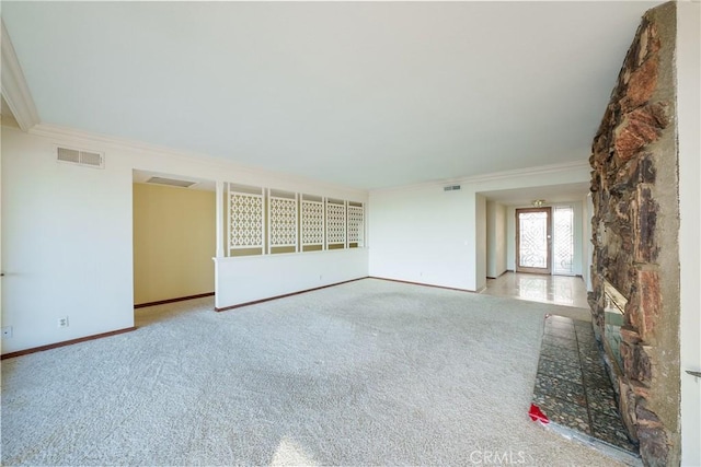 unfurnished living room featuring light colored carpet and crown molding